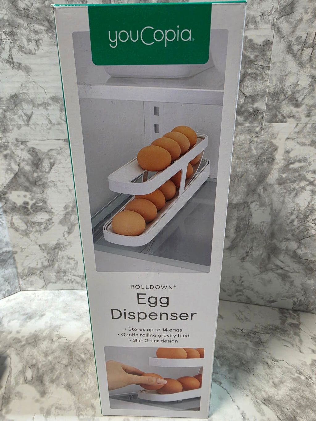 youCopia egg dispenser packaging on a marble surface