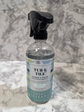 Bottle of 'Tubs & Tile' cleaner on a textured gray surface
