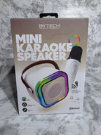 Box of a mini karaoke speaker with colorful design on a marble surface