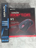 Corsair Raptor M3 gaming mouse box on a textured surface
