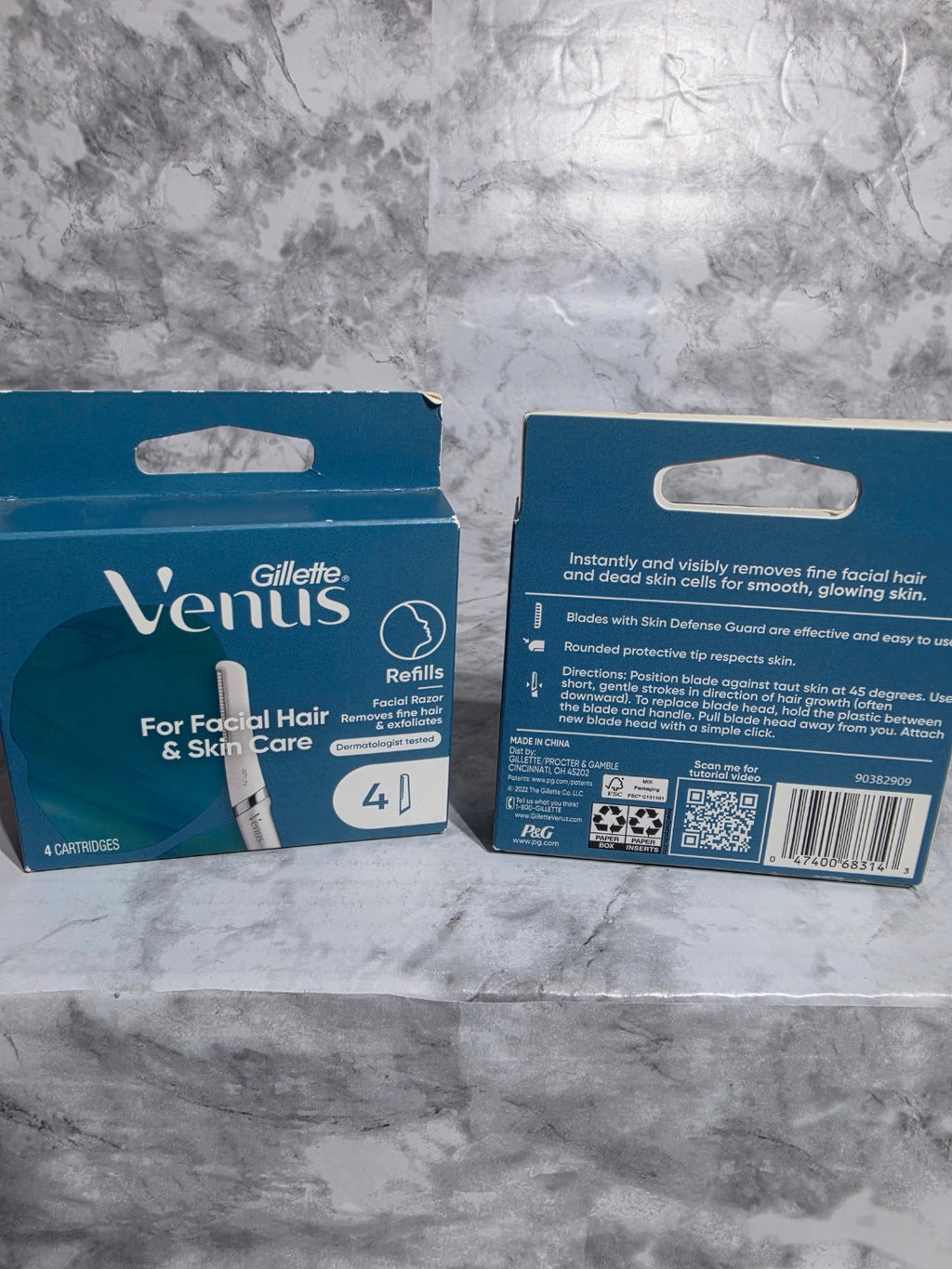 Two boxes of Gillette Venus razors on a marble surface
