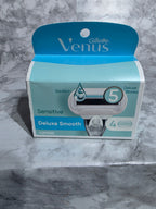 Gillette Venus razor packaging on a marble surface