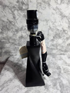 Black metal object with a cable on a marble surface