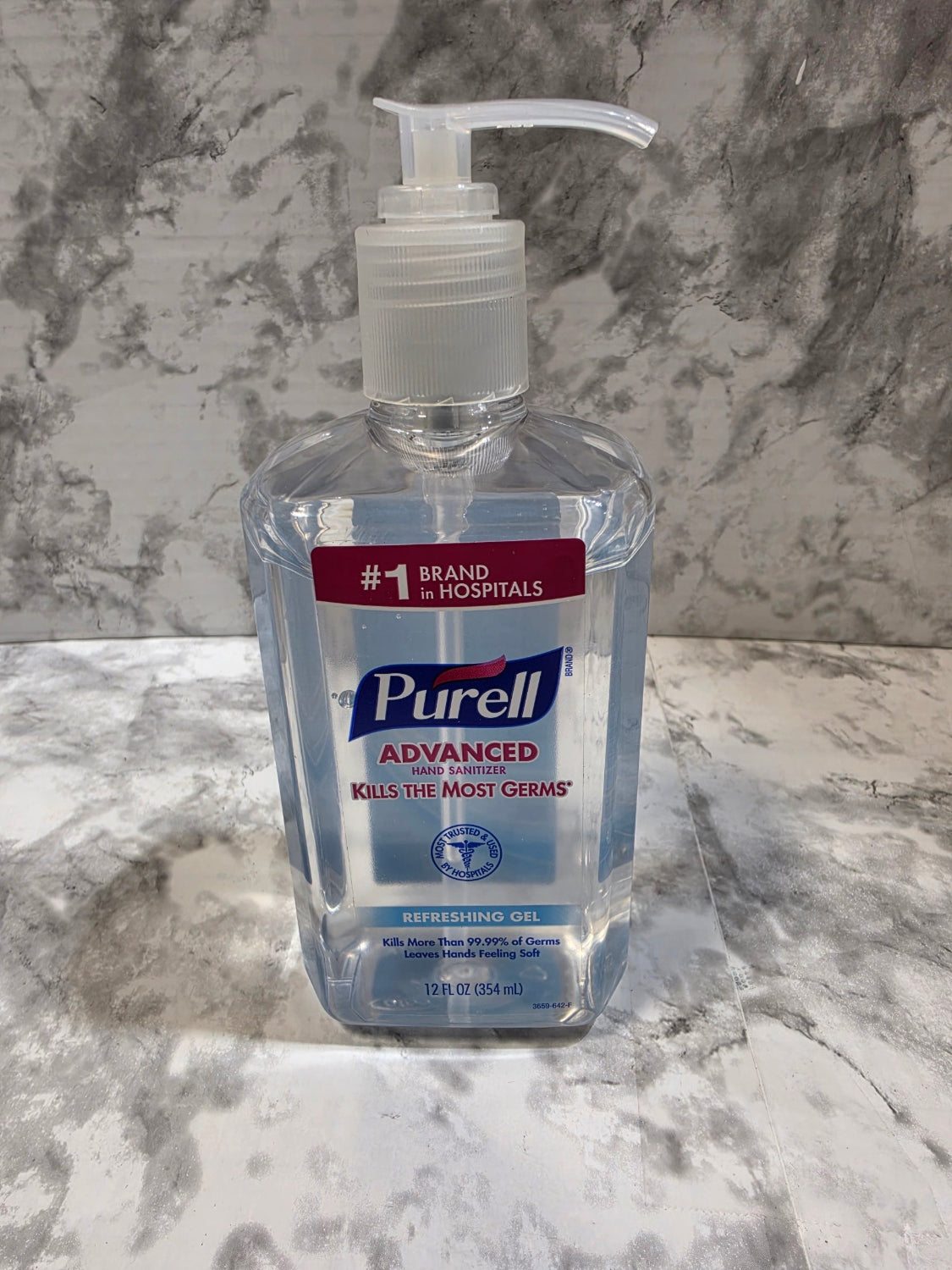 Purell hand sanitizer bottle on a marble surface