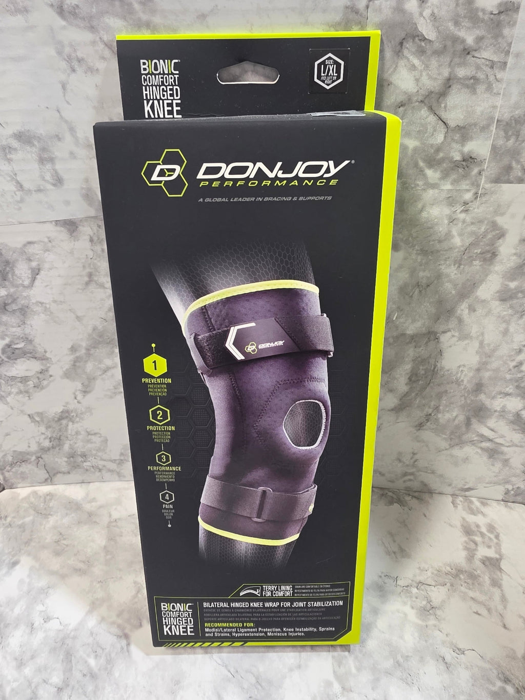 DonJoy Performance knee brace packaging on a marble surface