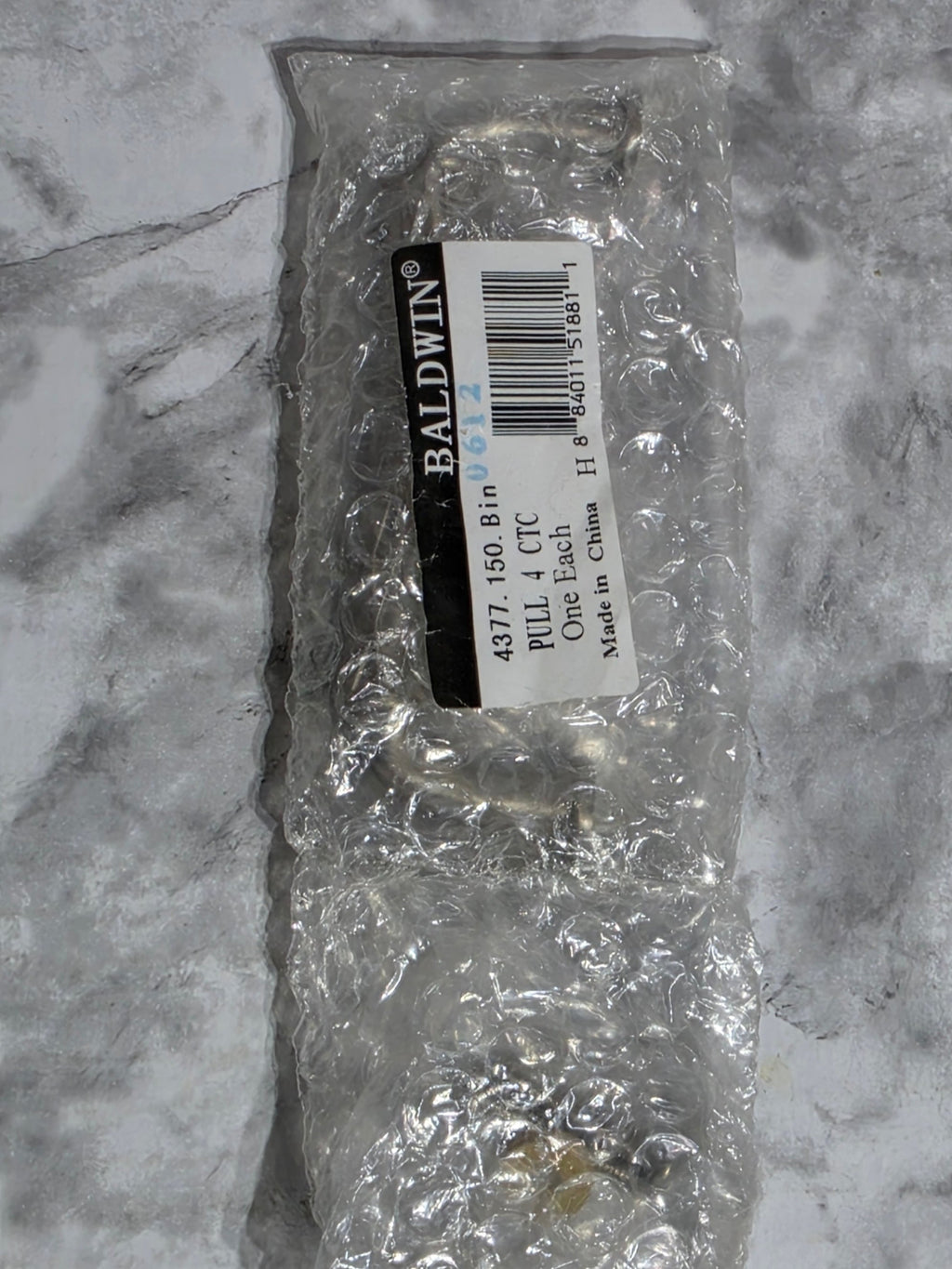 Packaged item with a label on a marble surface
