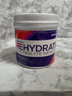 Container of Rehydrate electrolyte drink mix on a marble surface