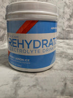 Container of Rehydrate Electrolyte Drink Mix on a marble surface