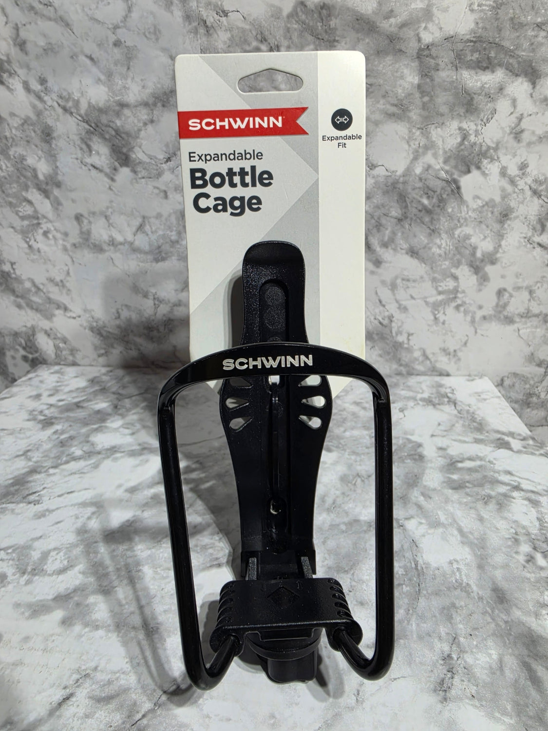 Black Schwinn expandable bottle cage on a gray marble surface
