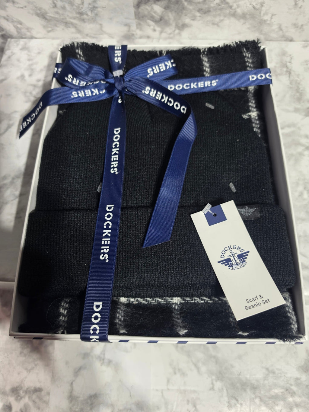 Box of Dockers socks with a blue ribbon on a marble surface