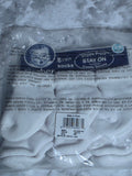 Packaged white socks with a label on a marble surface