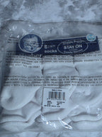 Packaged white socks with a label on a marble surface