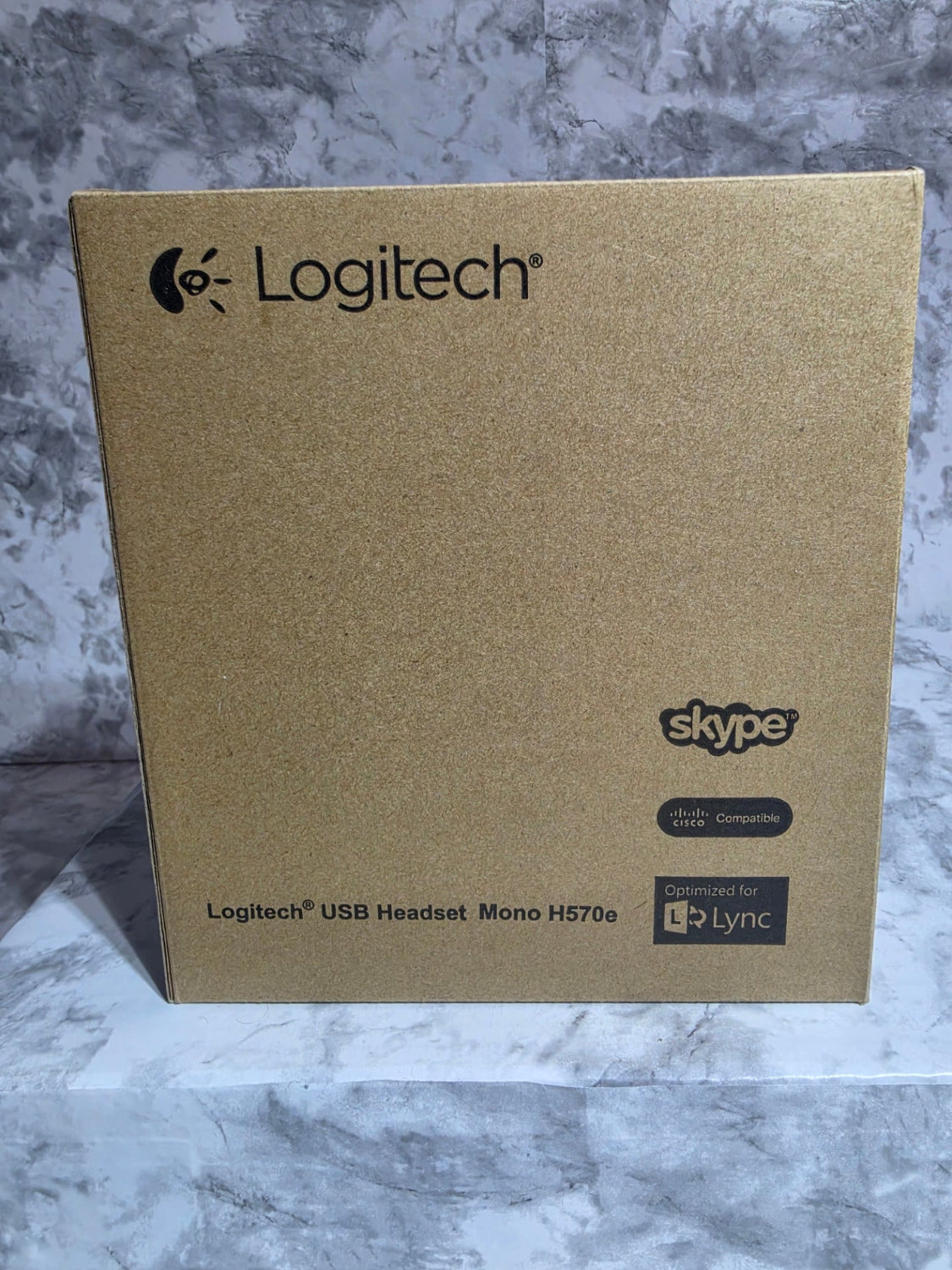 Logitech USB headset box on a marble surface