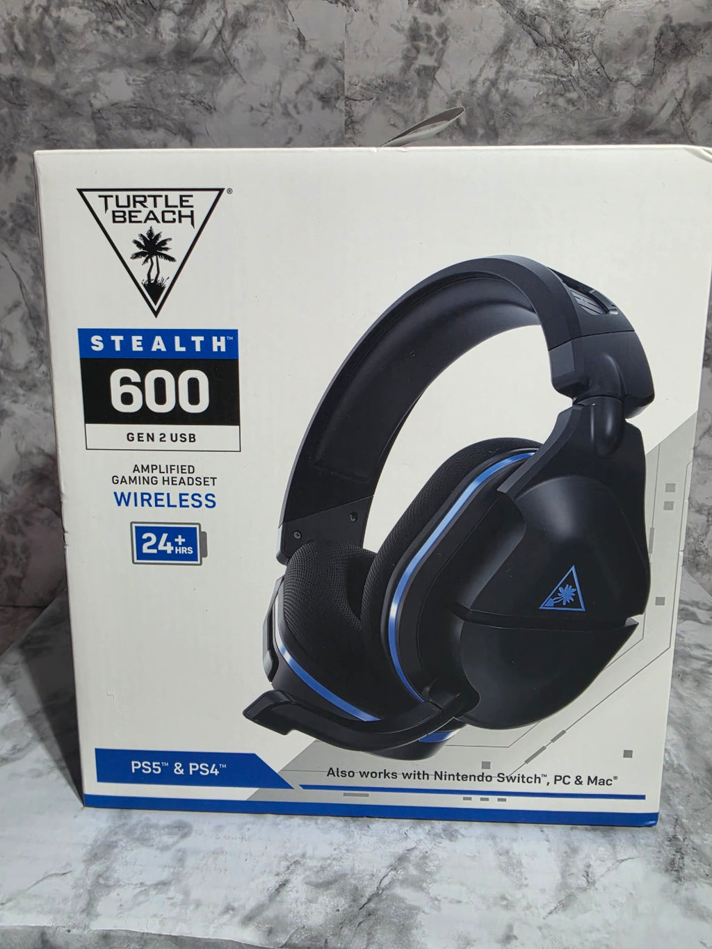 Turtle Beach Stealth 600 gaming headset on a box with a marble background