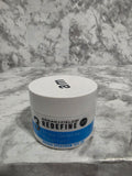 Jar of '3 Redefine' sunscreen on a textured surface