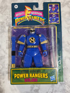 Blue Power Ranger figure in packaging with 'Mighty Morphin Power Rangers' branding on a textured surface.