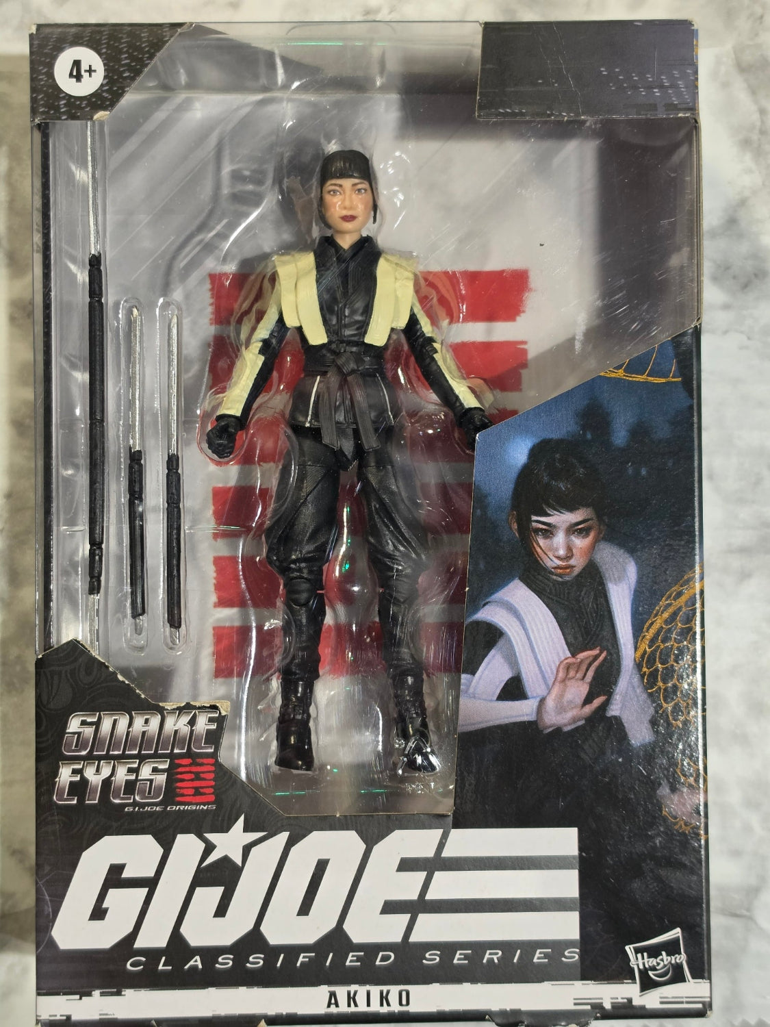 G.I. Joe action figure in packaging with character image on a textured surface