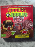 Board game box for 'Apples to Apples' on a gray surface