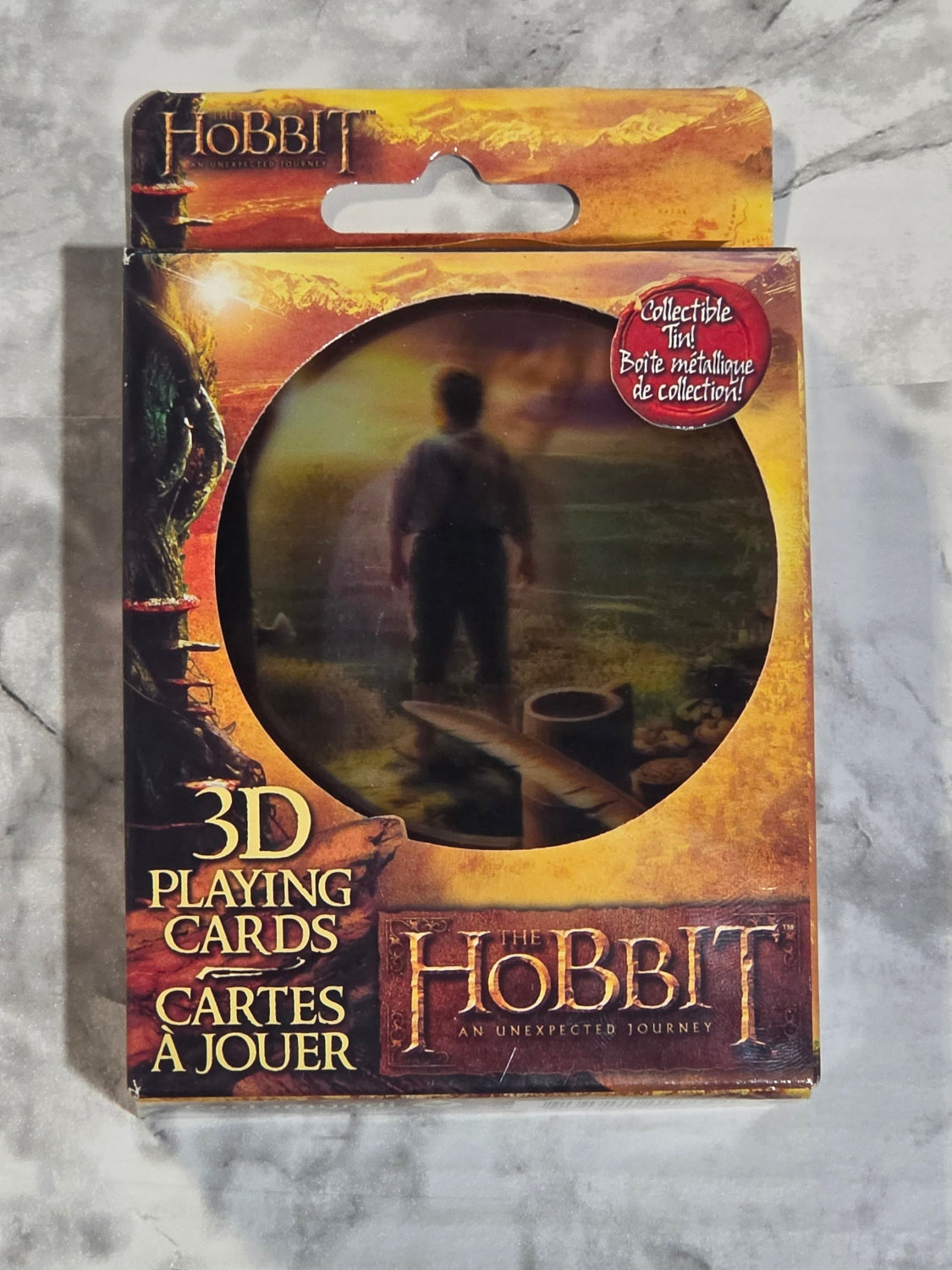 Pack of 'The Hobbit' 3D playing cards on a gray surface