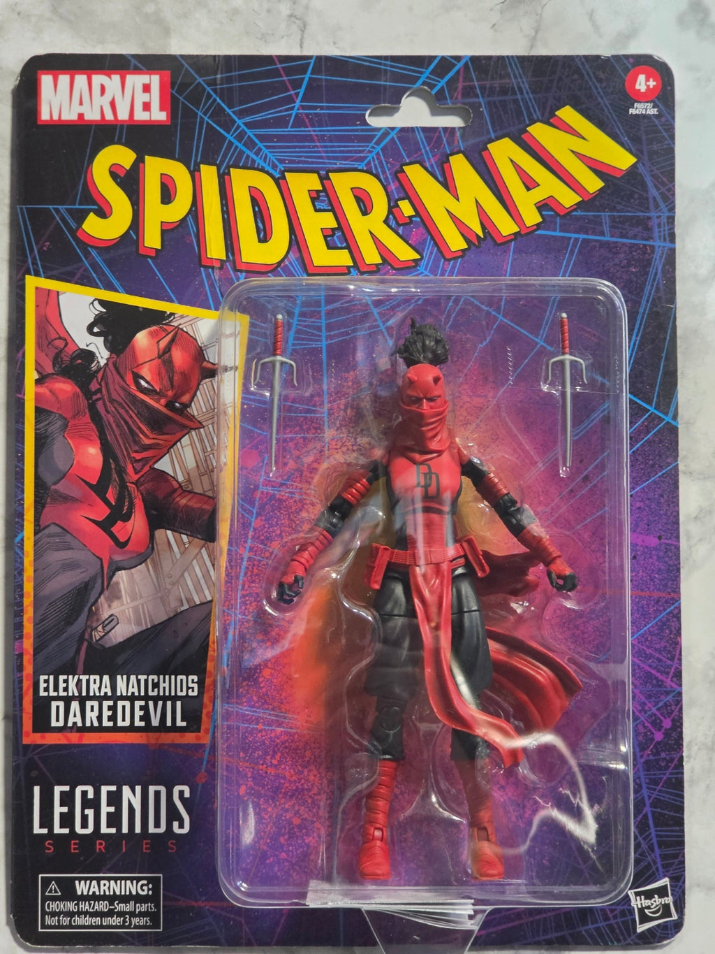 Marvel Legends Spider-Man action figure in packaging on a gray surface