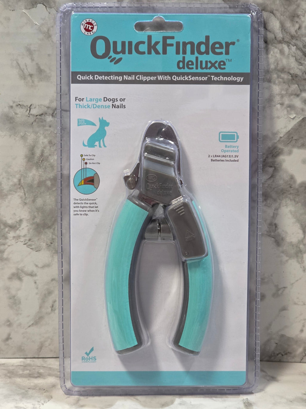 Pet nail clipper in packaging on a marble surface