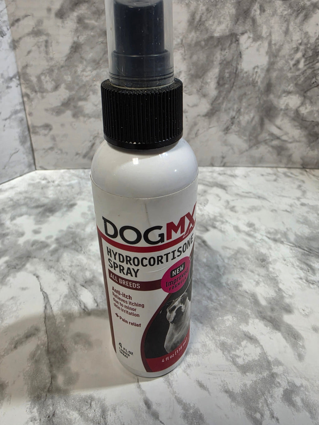 DogMD Hydrocortisone Spray bottle on a marble surface