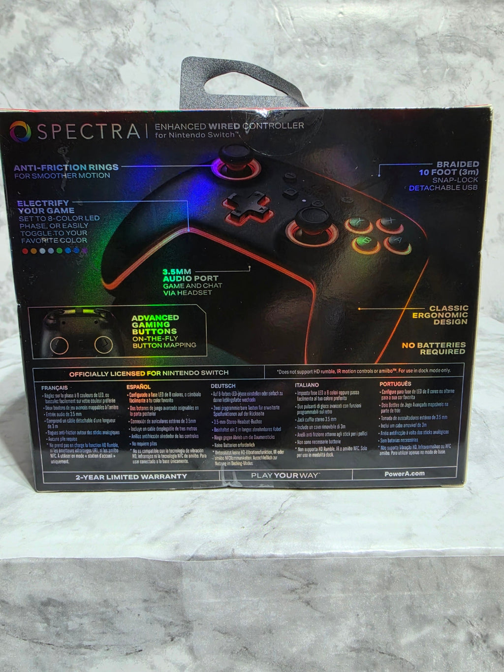 Gaming controller box with colorful LED lights on a gray surface