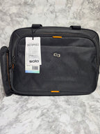 Black suitcase with a visible brand tag on a gray marble surface