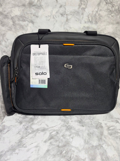 Black suitcase with a visible brand tag on a gray marble surface