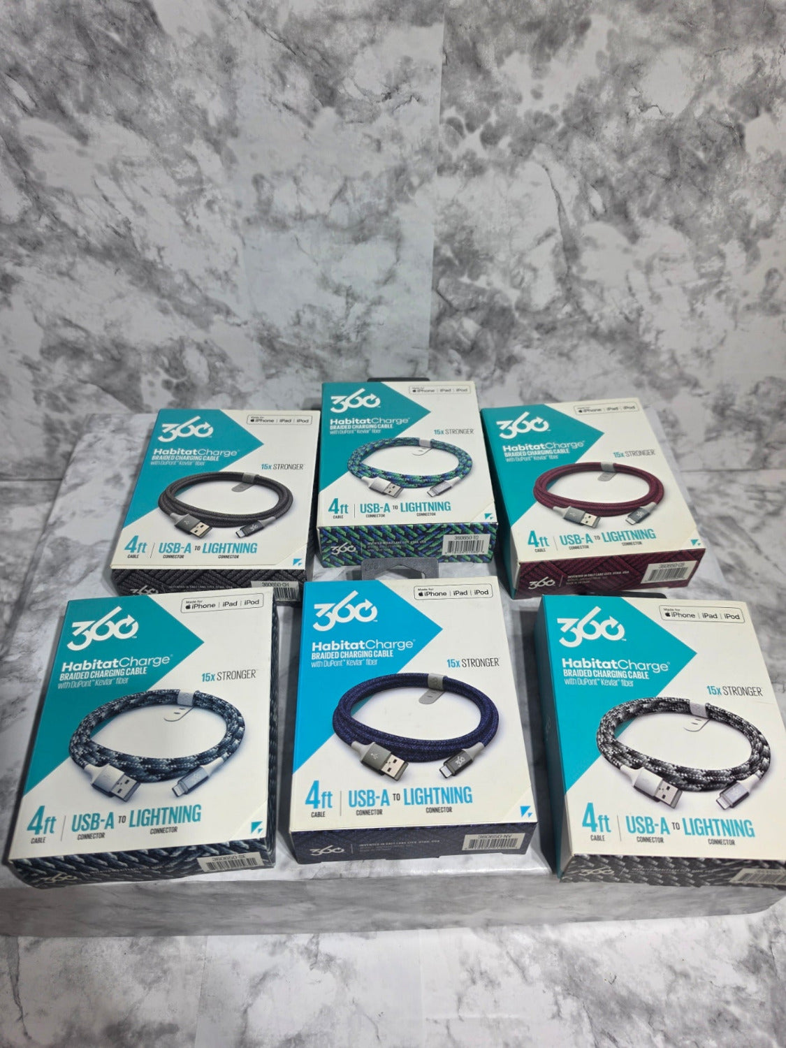 Multiple boxes of 360° Technology headlamps on a gray concrete surface