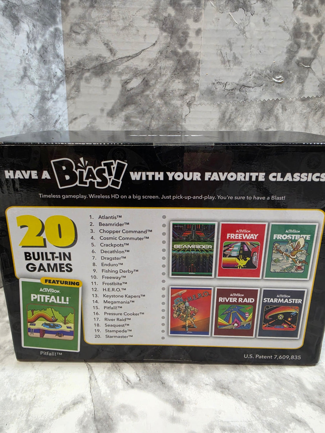 Card game box with colorful game cards on a marble surface