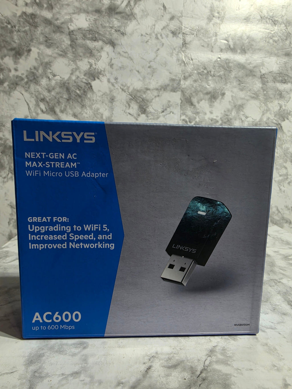 Linksys USB adapter packaging on a marble surface