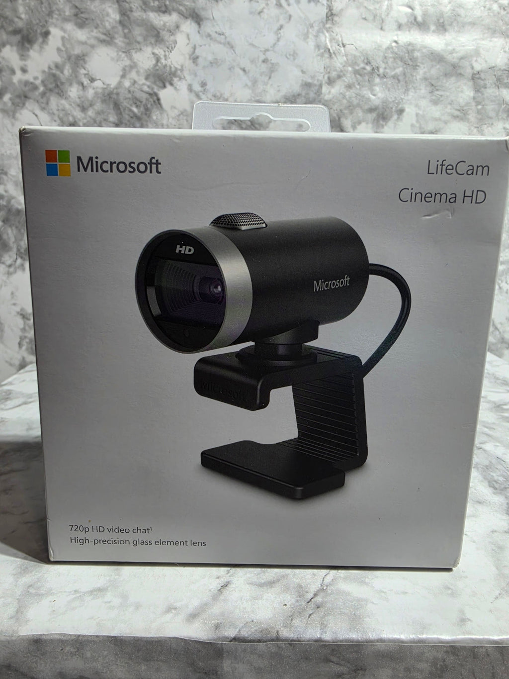 Microsoft LifeCam Cinema HD camera in its packaging on a marble surface