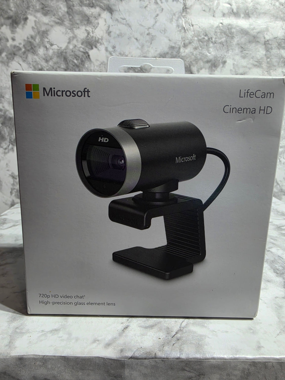 Microsoft LifeCam Cinema HD camera in its packaging on a marble surface