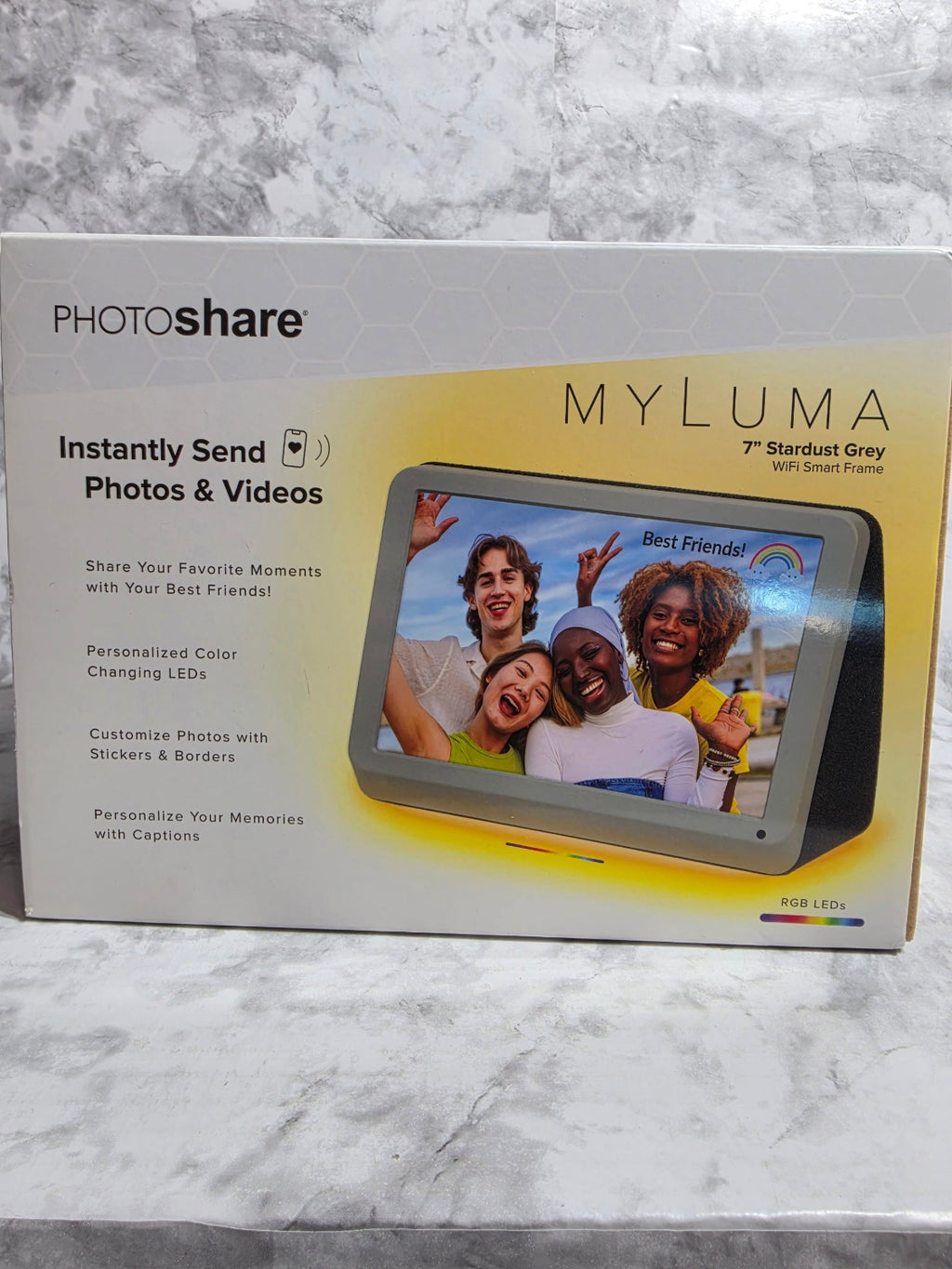 MYLUMA PhotoShare device packaging on a marble surface