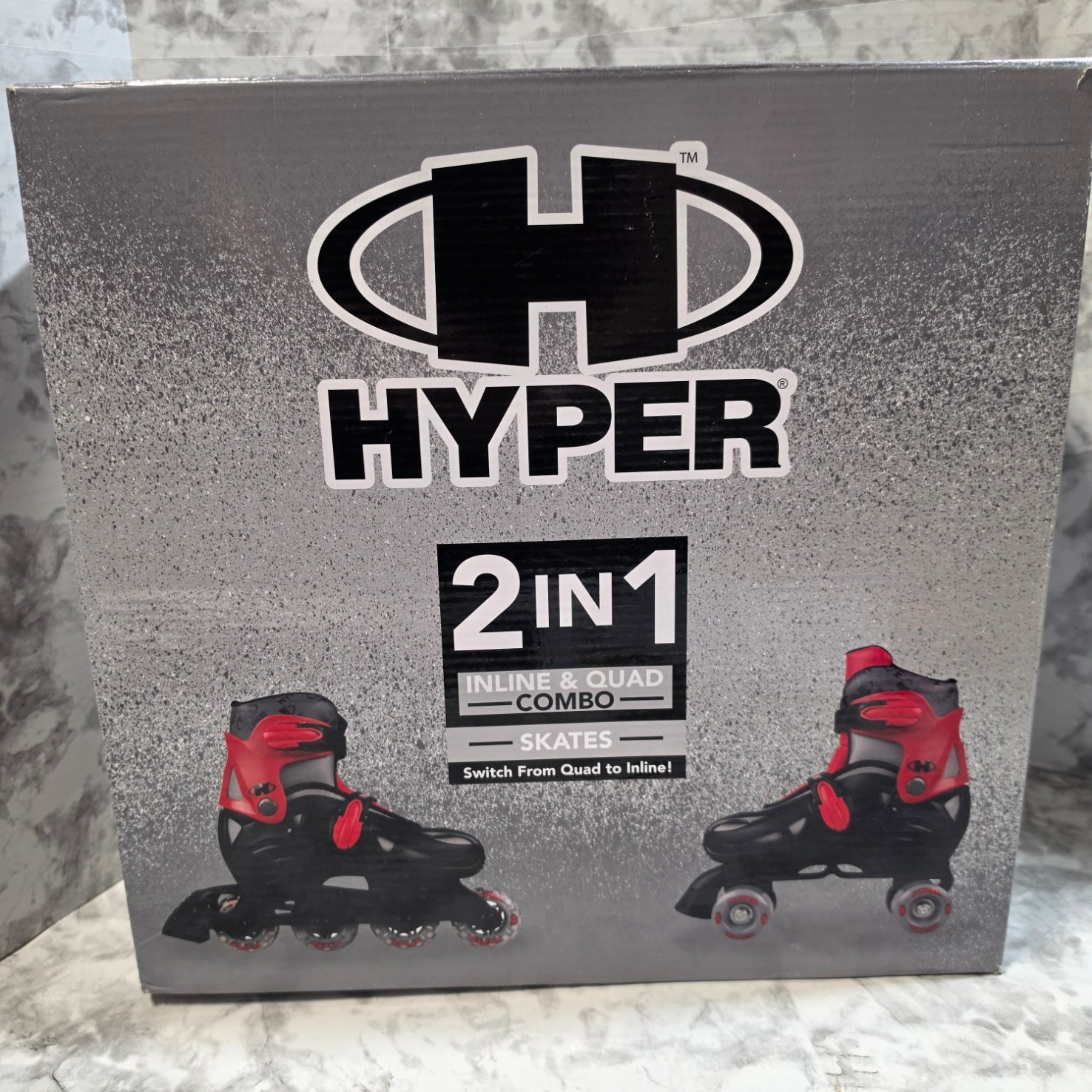 Box for Hyper inline skates with 2-in-1 quad and skate combo on a gray surface.