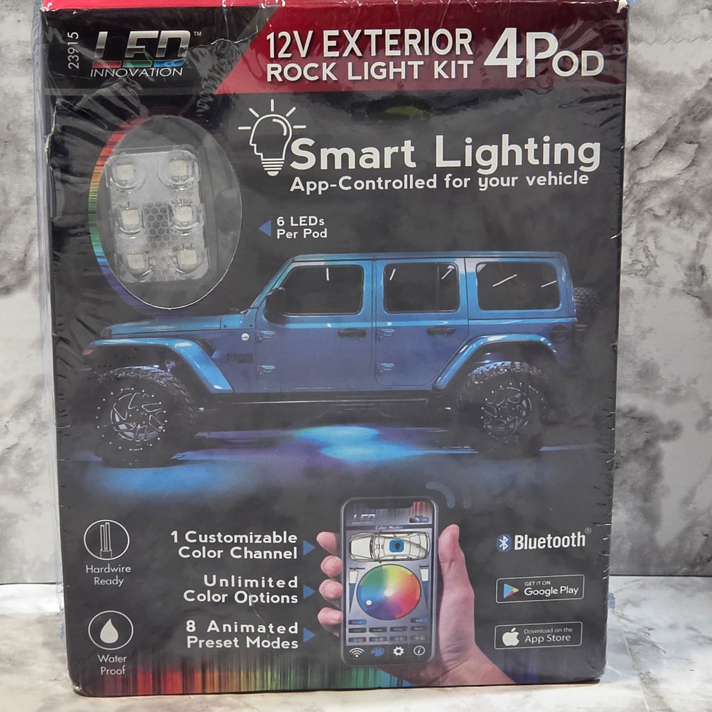 Boxed 12V exterior rock light kit with smart lighting features on a marble surface