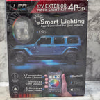 Boxed 12V exterior rock light kit with smart lighting features on a marble surface