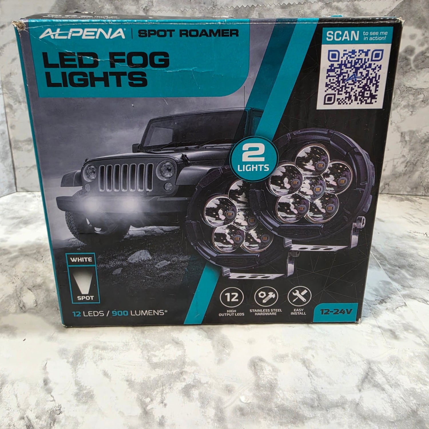 Alpina LED fog lights packaging on a textured surface