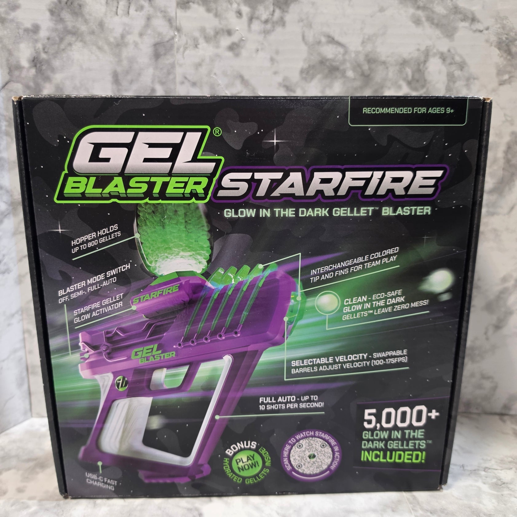 Box of Starfire Gel Blaster with purple and green design on a gray surface
