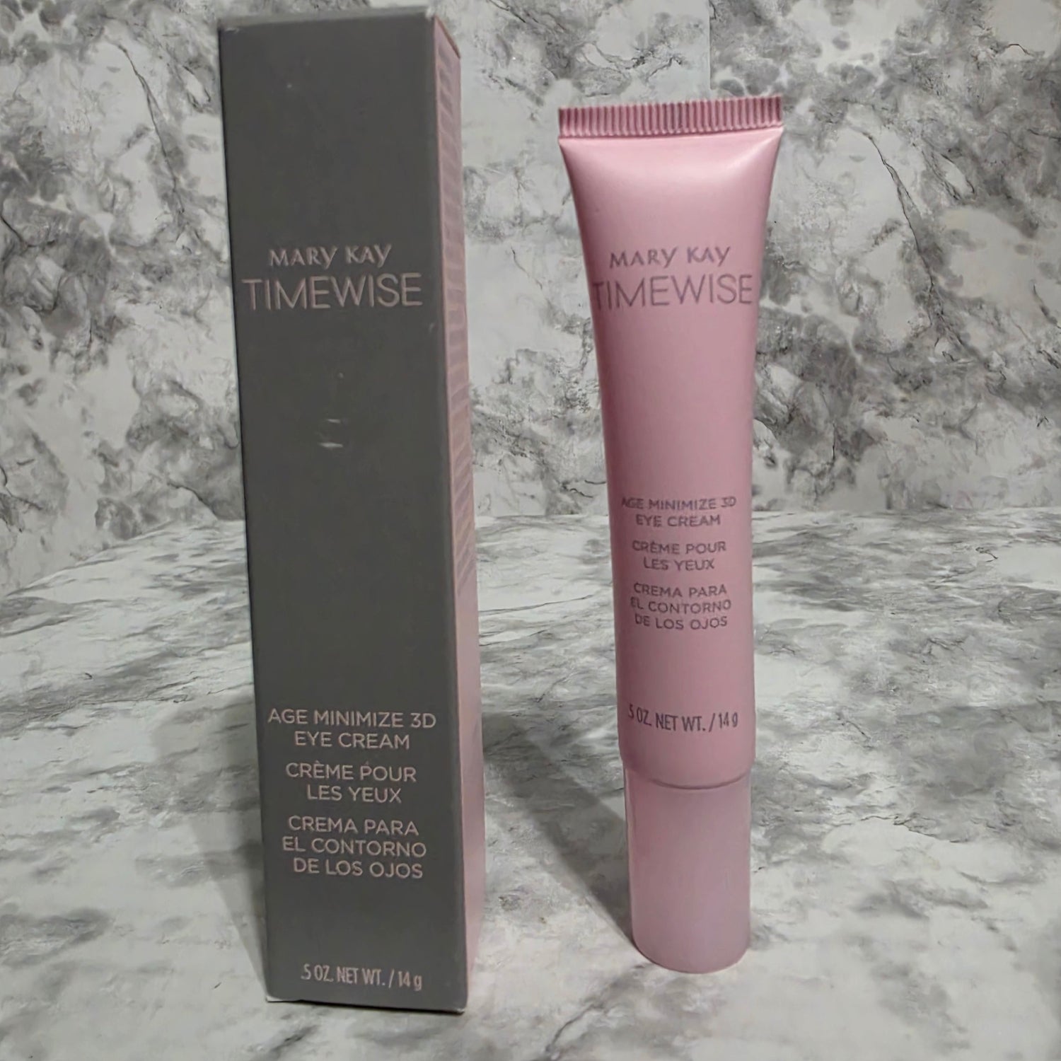 Mary Kay TimeWise eye cream tube and packaging on a marble surface