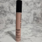 Mary Kay concealer stick on a textured gray background
