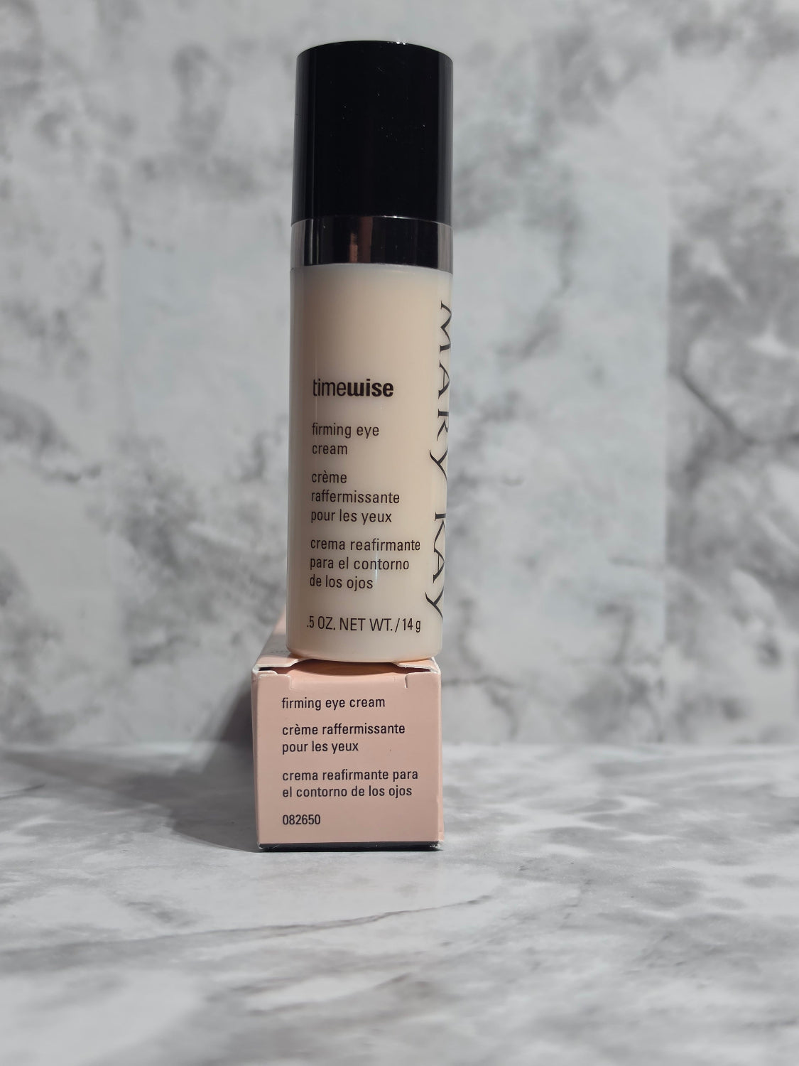 Makeup product with 'Mary Kay' branding on a gray marble background