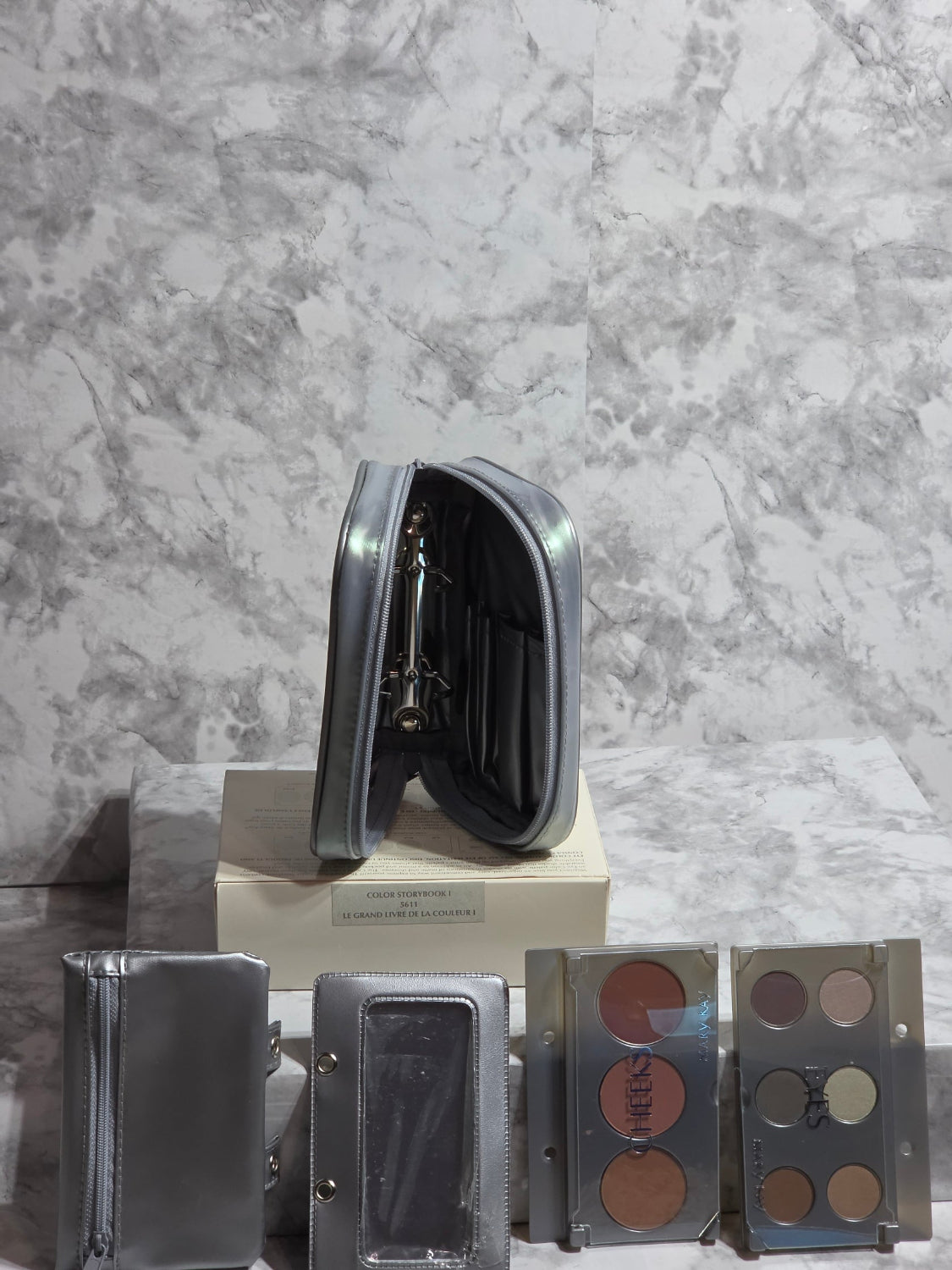 Makeup palette with various shades on a marble surface
