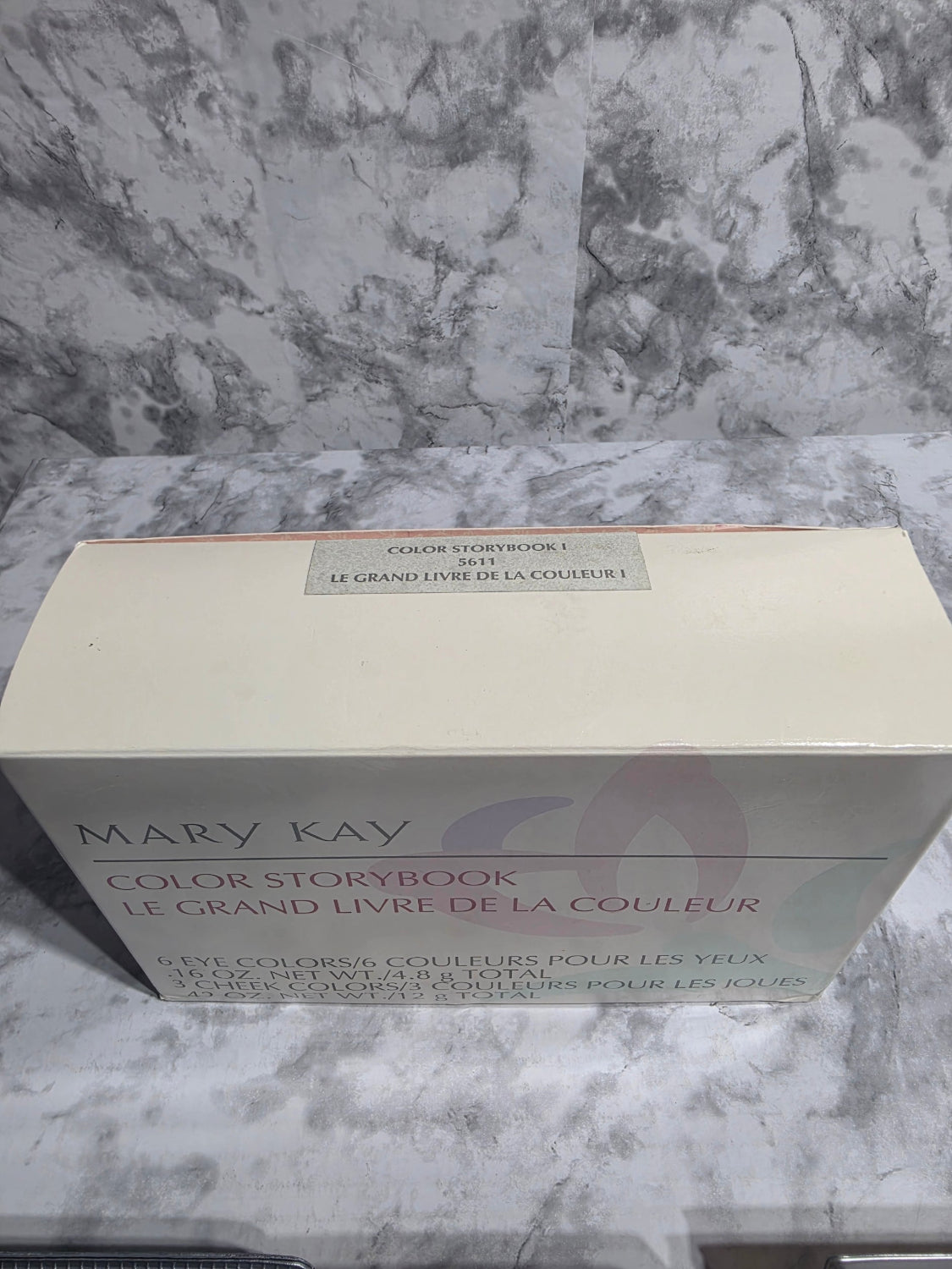 Mary Kay color textbook on a marble surface
