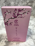 Pink product packaging with floral design and 'Avon' branding on a marble surface