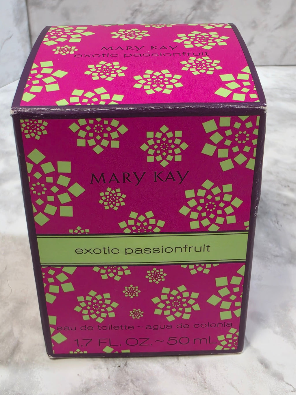 Mary Kay exotic passionfruit product packaging on a textured surface