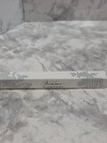 Silver book with decorative cover on a marble surface