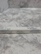 Silver book with decorative cover on a marble surface