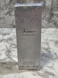 Perfume bottle packaging with floral design and brand name on a marble background